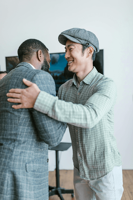 A mortgage broker greets a happy client with a warm handshake